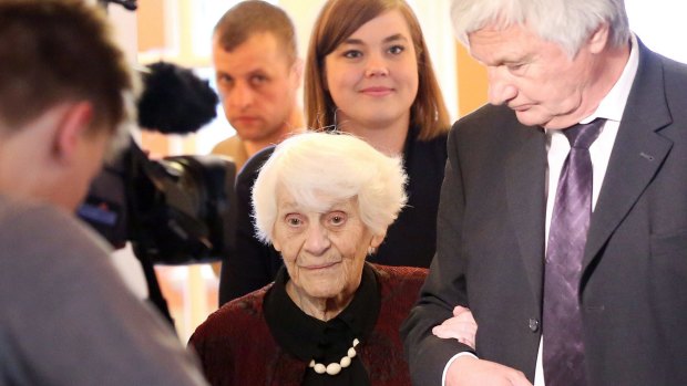 Ingeborg Syllm-Rapoport, 102, arrives with the dean of Hamburg's UKE University Medical Centre, Uwe Koch-Gromus, for a ceremony during which she received her PhD certificate.