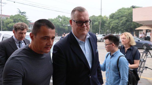 Jeff Sikima, centre, the husband of Jenny Jiang, who had arranged visas for Crown clients and was one of only three defendants on bail.