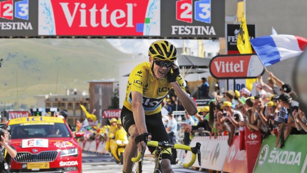 Safely home: Chris Froome crosses the finish line after stage 20.