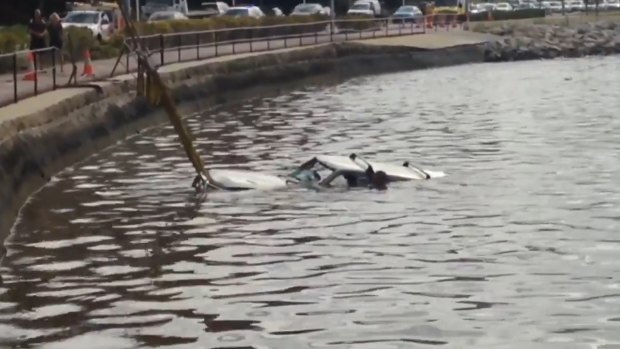 The vehicle being pulled from the Swan River on Monday. 