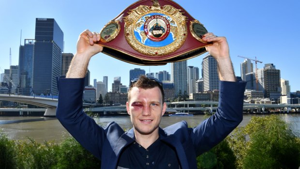 Bruised but not beaten: Jeff Horn proudly displays his WBO welterweight champion’s belt in Brisbane on Monday.