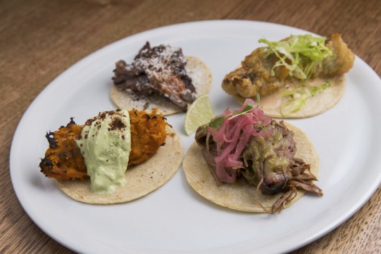 Taco flight with pumpkin, lamb shoulder, fried barramundi and beef tri-tip fillings.