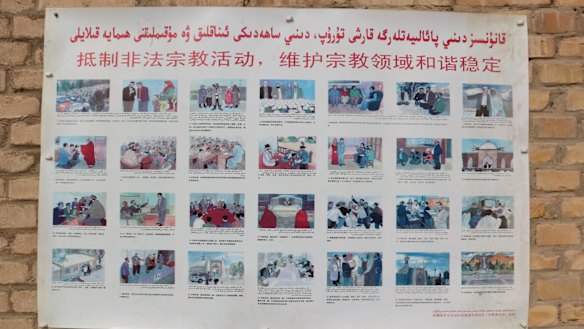 A poster at a mosque in the Xinjiang village of Kuibagh in 2014 shows banned religious practices. A patchwork approach to enforcement has prompted the new law.