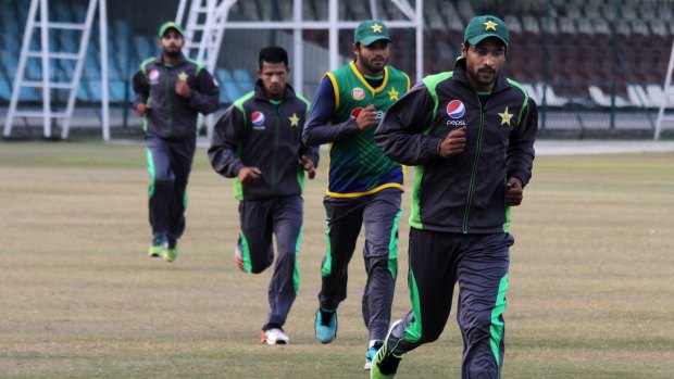 Mohammad Amir, right, takes part in a training camp with other players in Lahore.
