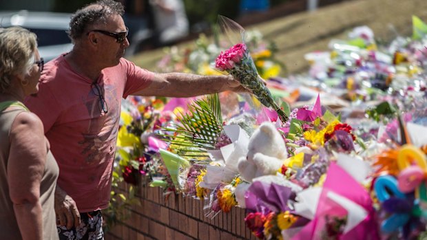 A couple pay their respects at Dreamworld on Thursday.