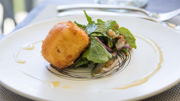A dish of crumbed goats chevre, fig preserve, rocket and walnuts at La Petite Ferme's restaurant.