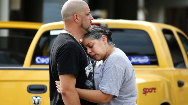 Ray Rivera, a DJ at Pulse nightclub, is consoled by a friend after the shooting.