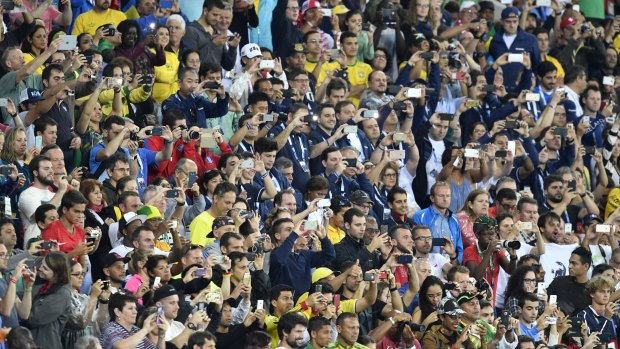 Spectators watch the medal ceremony for the men's 100m awarding Jamaica's Usain Bolt the gold medal, United States' Justin Gatlin silver and Canada's Andre De Grasse  bronze in Rio on Monday.