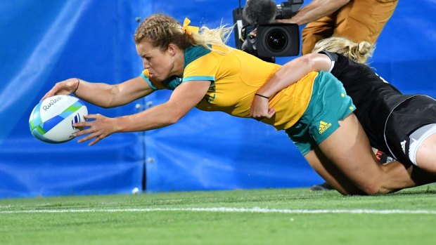 Australian Emma Tonegato scores a try in the sevens final against New Zealand.  