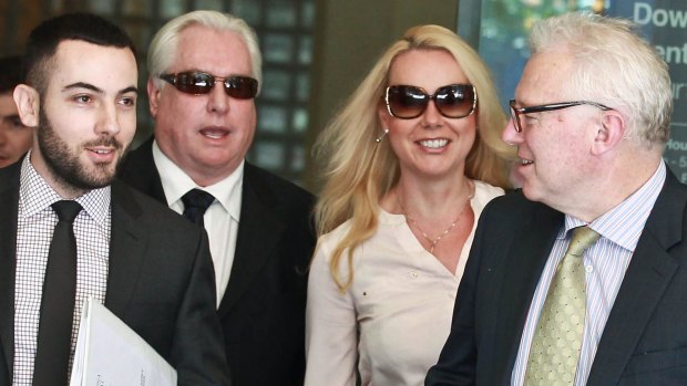 Music promoter Andrew McManus, second left, and partner Kayla Evison, third left, leave Downing Centre court. 