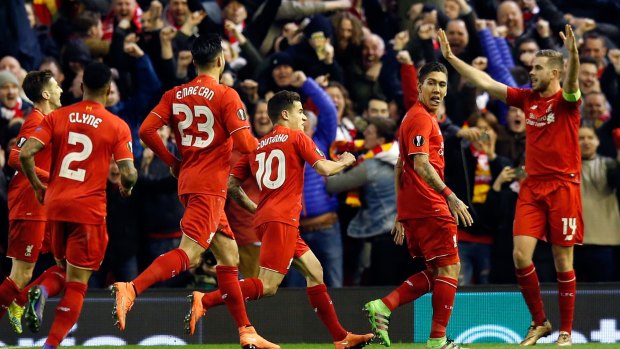 Liverpool's Roberto Firmino, second from right, celebrates after scoring his side's second goal.