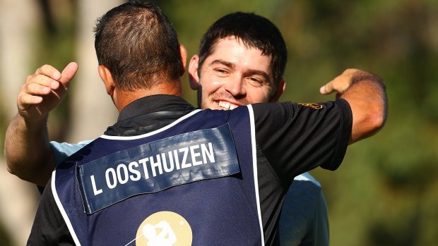 Good win: Louis Oosthuizen of South Africa embraces his caddie Wynard Stander after his success.