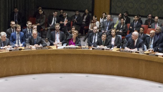 US ambassador to the UN Samantha Power, centre, raises her hand to abstain during the UN Security Council vote on December 23.
