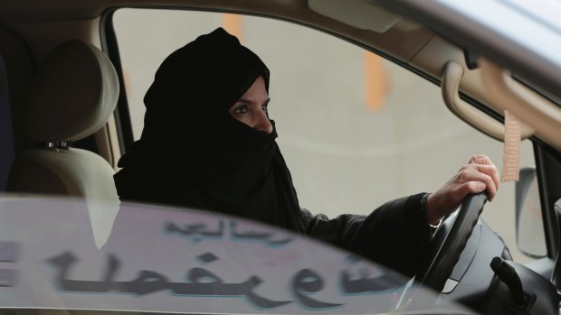 Aziza Yousef drives a car on a highway in Riyadh, Saudi Arabia, as part of a 2014 campaign to defy Saudi Arabia's ban on women driving. 
