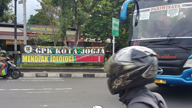 Indonesian crackdown: banner reads 'Reject communist ideology'.