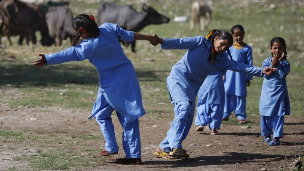 Girls play before classes at their government-run school on the outskirts of Jammu.