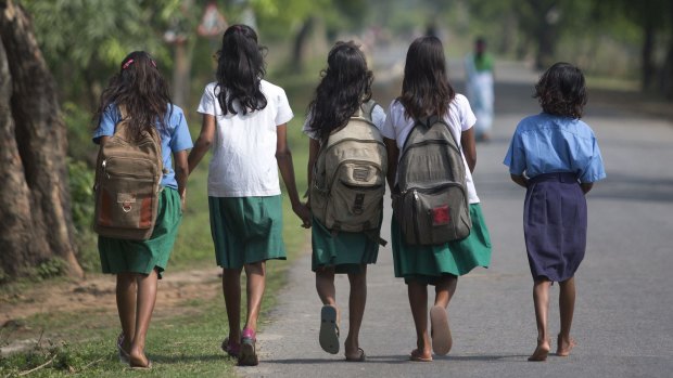 Indian girls walk to a school in eastern India.