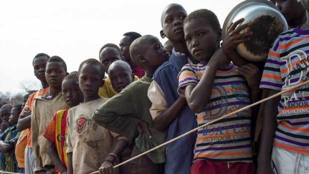 South Sudanese children wait for food at the Bidi Bidi refugee camp over the border in Uganda.