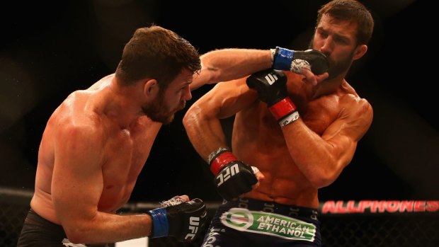 Michael Bisping connects with a left to the face of Luke Rockhold at Allphones Arena in a 2014 bout in Sydney.