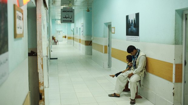 a child waits for an X-ray with her father at Kunduz's hospital before the bombing.
