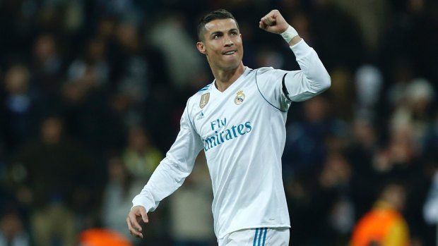 High five: Real Madrid forward Cristiano Ronaldo edged out Messi for this year's top spot and his fifth Ballon d'Or.