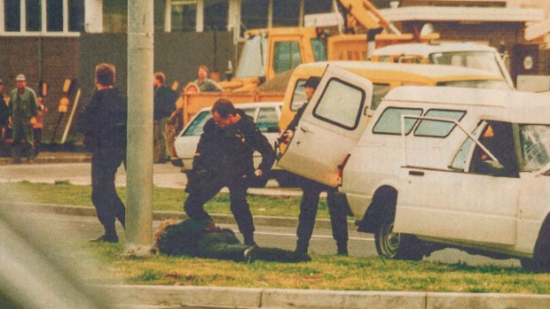 Special Operations Group members confront Stephen Asling, who was trying to escape at speeds of up to 80km/h in a 1992 heist.