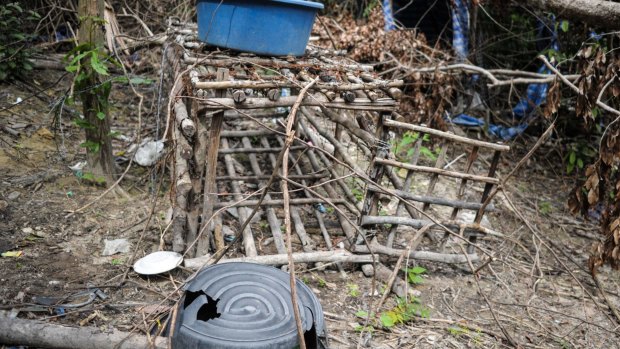 A small cage is seen at an abandoned migrant camp used by people-smugglers in a jungle at Bukit Wang Burma in the Malaysian northern state of Perlis.