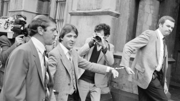 Christopher Dale Flannery being led handcuffed into the City Watch-house to be charged with murder in October, 1981.