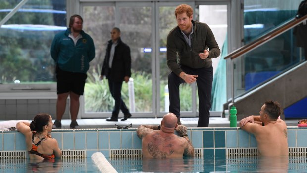 Prince Harry meets defence veteran swimmers after touring the Sydney International Aquatic Centre, where the Invictus Games will be held in 2018.