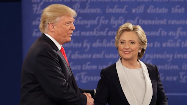 Donald Trump and Hillary Clinton shake hands.