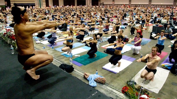 Bikram Choudhury, front, teaches a hot yoga class in the Los Angeles Convention Centre in 2003.