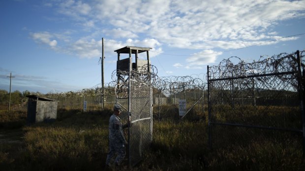 A soldier closes the gate at the now abandoned Camp X-Ray  at Guantanamo Bay Naval Base, Cuba.