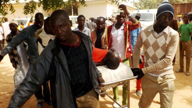 A man injured in a suicide blast is transported at the General Hospital in northeast Nigerian town of Potiskum. 
