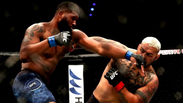 Trading blows: American Curtis Blaydes goes toe to toe with Mark Hunt during UFC 221 at Perth Arena.