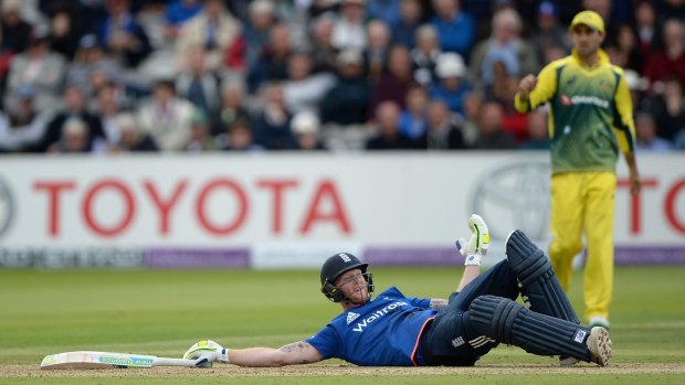 Ben Stokes lies on the ground after blocking a ball thown by Mitchell Starc.