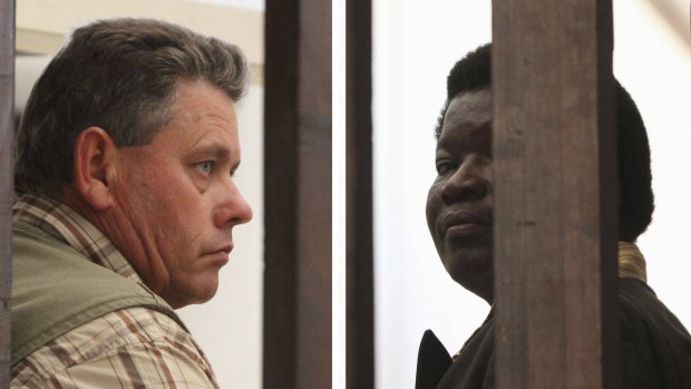 Zimbabwean safari operator Trymore Ndlovu, right, and fellow countryman and hunter Theo Bronkhorst waiting to appear in Hwange magistrates court last month.