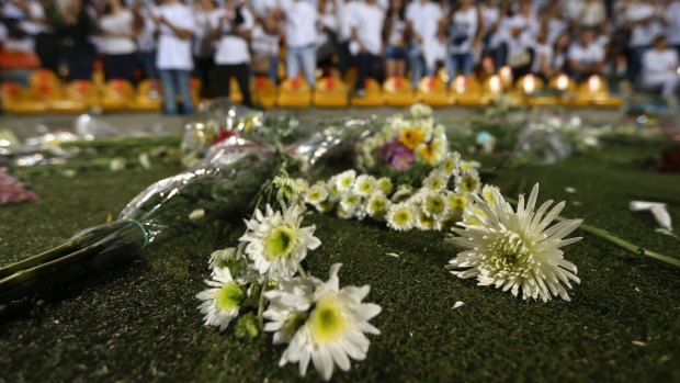 Flowers lay on the pitch in the Atanasio Girardot stadium in Colombia, where the Chapecoense club had been scheduled to play. 