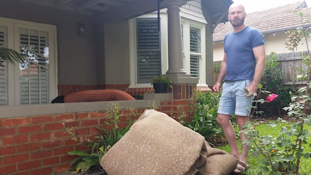 Elwood resident cleans up on Friday morning.