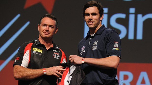 St Kilda coach Alan Richardson presents a jumper to No.1 draft pick Patrick McCartin.