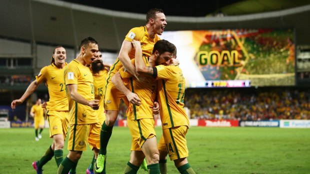 Mathew Leckie of the Socceroos celebrates with teammates after scoring the second goal against the United Arab Emirates on Tuesday.