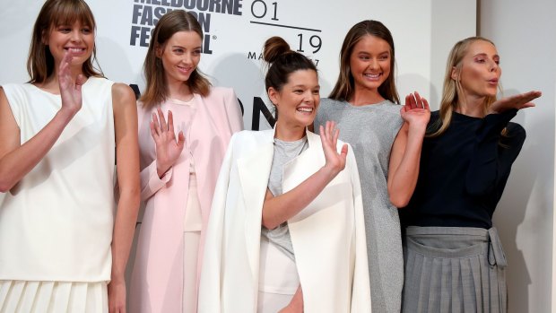 Kacey Devlin (centre) with models wearing her designs after she was named the winner of the National Designer Award at the Melbourne Fashion Festival on Wednesday.