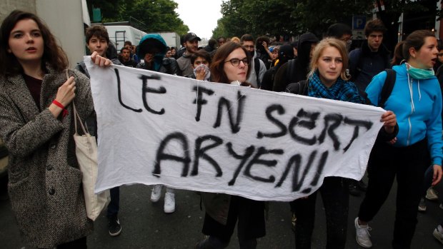 High school children demonstrate with a banner reading "The National Front is pointless".