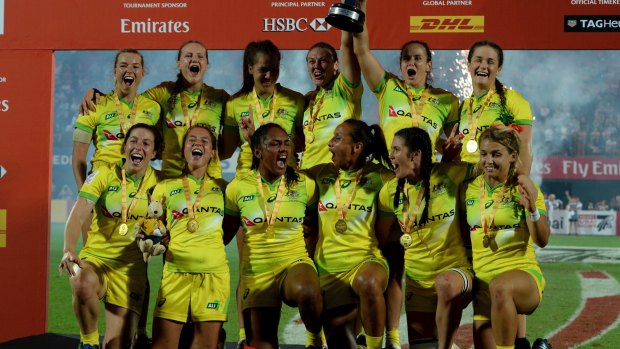 Golden girls: Australia's players celebrate 0-34 victory over the United States in the final of the World Rugby Women's Sevens Series in Dubai.