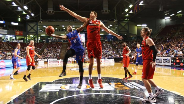 Kenyon McNeail of the 36ers is blocked by Tom Jervis earlier this month.