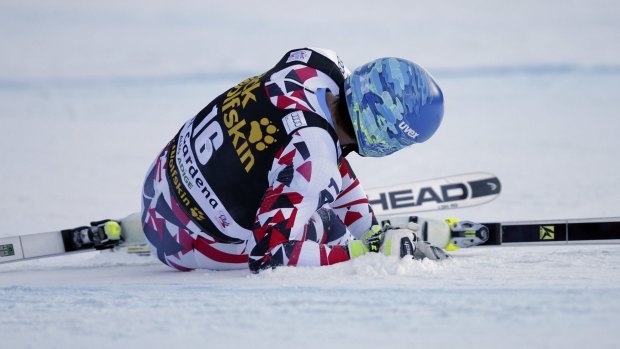 Austria's Matthias Mayer lies on the snow after crashing on Saturday