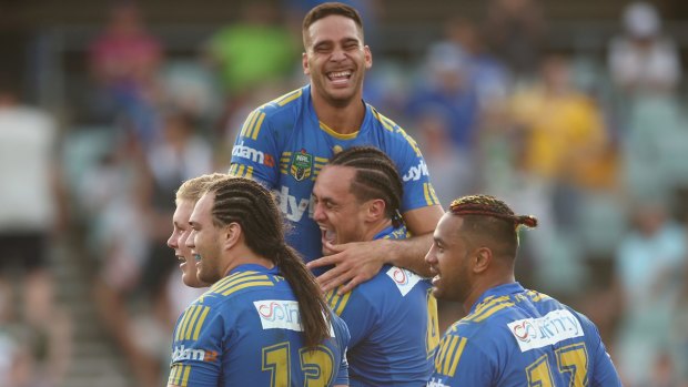 Happy, but for how long?: Parramatta players celebrate a try against Canberra.