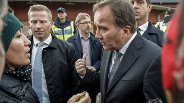 Prime Minister Stefan Lofven, right, attends the school where the violence occurred on Thursday.