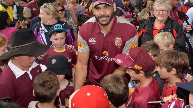 PROSERPINE, AUSTRALIA - JUNE 30:  Greg Inglis signs autographs for fans during the Queensland Maroons State of Origin fan day on June 30, 2015 in Proserpine, Australia.  (Photo by Bradley Kanaris/Getty Images)