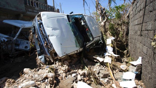 A car stands on its side after being blown away by winds brought by Hurricane Matthew in Jeremie, Haiti.