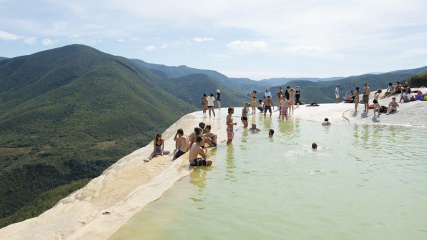 Tourists enjoy the water and dramatic scenery at Hierve el Agua in Oaxaca State, Mexico.